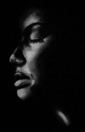Black and white close-up photograph of a black woman's face.